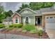 Attractive home with brick and siding, complemented by a beautifully landscaped front yard at 11615 Chadburn Ln, Charlotte, NC 28215