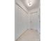 Hallway featuring large closet doors, neutral paint and tile, and overhead lighting at 11615 Chadburn Ln, Charlotte, NC 28215