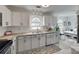 Bright kitchen with white cabinets, granite countertops, and stainless steel appliances offers charm and functionality at 11615 Chadburn Ln, Charlotte, NC 28215
