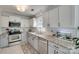 Well-lit kitchen with granite countertops, stainless steel appliances, and ample cabinet space at 11615 Chadburn Ln, Charlotte, NC 28215