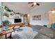 Cozy living room featuring a ceiling fan, modern furnishings, and stylish decor at 11615 Chadburn Ln, Charlotte, NC 28215