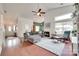 Spacious living room with a fireplace, vaulted ceiling, and seamless flow to other living areas at 11615 Chadburn Ln, Charlotte, NC 28215