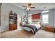Spacious main bedroom features soft, natural light, a ceiling fan, and a comfortable bed with tasteful decor at 11615 Chadburn Ln, Charlotte, NC 28215