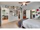 Bright main bedroom with eclectic decor featuring a comfortable bed, shelving, and seamless bathroom access at 11615 Chadburn Ln, Charlotte, NC 28215