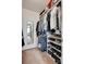 Organized walk-in closet with shelves, rods, and a full length mirror reflects into an adjacent room at 11615 Chadburn Ln, Charlotte, NC 28215