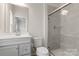 Bathroom featuring a glass enclosed shower, a modern sink and bright natural light at 1204 May Apple Dr, Matthews, NC 28104