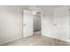 Bedroom with neutral carpet featuring open door and closet doors at 1204 May Apple Dr, Matthews, NC 28104