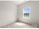 Bedroom with neutral carpet, bright window and light gray walls at 1204 May Apple Dr, Matthews, NC 28104