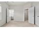 Bedroom showing open doorway to a bathroom and a closet with wire shelving at 1204 May Apple Dr, Matthews, NC 28104