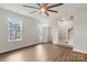Spacious bedroom with natural light from two windows, ceiling fan, and en-suite bathroom access at 1204 May Apple Dr, Matthews, NC 28104