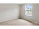 Bright and airy bedroom showcasing neutral carpet, a window with a view, and a serene ambiance at 1204 May Apple Dr, Matthews, NC 28104
