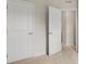 Hallway with neutral carpet featuring white doors and baseboards at 1204 May Apple Dr, Matthews, NC 28104