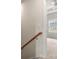 Hallway with a wooden railing leading to a room with neutral carpet and bright natural light at 1204 May Apple Dr, Matthews, NC 28104