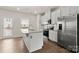 Kitchen island with stainless appliances and access to back porch at 1204 May Apple Dr, Matthews, NC 28104