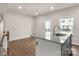 Kitchen island features a granite countertop with view of back porch at 1204 May Apple Dr, Matthews, NC 28104
