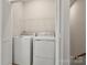 Laundry room showing full size washer and dryer with wire shelving at 1204 May Apple Dr, Matthews, NC 28104
