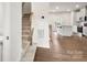 View of staircase leading to the kitchen with island and stainless steel appliances in open floor plan at 1204 May Apple Dr, Matthews, NC 28104
