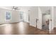 Spacious living room with wood-look floors, natural light from windows, and an inviting staircase at 1204 May Apple Dr, Matthews, NC 28104