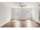 Bright living room features hardwood floors, large windows and ceiling fan at 1204 May Apple Dr, Matthews, NC 28104