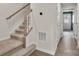 Stairway with neutral carpet and wooden railing connecting two floors, complemented by wood-look flooring at 1204 May Apple Dr, Matthews, NC 28104