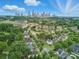 Aerial view of neighborhood and the city skyline in the background under a blue sky at 1228 Rising Oak Dr, Charlotte, NC 28206
