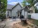 Backyard patio area with a firepit, dining table, grill, and privacy fence at 1228 Rising Oak Dr, Charlotte, NC 28206