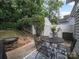 Backyard patio area with a firepit, dining table, and privacy fence at 1228 Rising Oak Dr, Charlotte, NC 28206