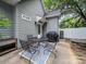Backyard patio area with a firepit, dining table, grill, and privacy fence at 1228 Rising Oak Dr, Charlotte, NC 28206
