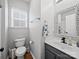 Well lit powder room featuring a decorative mirror and modern fixtures at 1228 Rising Oak Dr, Charlotte, NC 28206