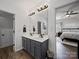 Bathroom boasts a double sink vanity, modern fixtures, and wood look tile flooring at 1228 Rising Oak Dr, Charlotte, NC 28206