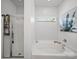 Bright bathroom features a large tub, a separate shower, and white tile surround at 1228 Rising Oak Dr, Charlotte, NC 28206