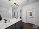 Well-lit bathroom with double sinks, soaking tub, and updated fixtures at 1228 Rising Oak Dr, Charlotte, NC 28206