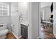 Powder room with modern vanity, toilet, and decorative fixtures, leads to home office at 1228 Rising Oak Dr, Charlotte, NC 28206
