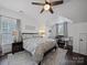 Cozy bedroom with neutral decor, ceiling fan, and comfortable queen-sized bed at 1228 Rising Oak Dr, Charlotte, NC 28206