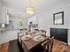 Inviting dining area with modern lighting, hardwood floors, and access to the kitchen at 1228 Rising Oak Dr, Charlotte, NC 28206
