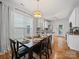 Bright dining area with modern lighting, hardwood floors, and direct access to the kitchen at 1228 Rising Oak Dr, Charlotte, NC 28206