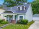 Charming two-story home featuring manicured lawn, a detached garage, and lovely curb appeal at 1228 Rising Oak Dr, Charlotte, NC 28206