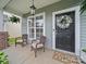 Inviting front porch featuring chairs, decor, and charming accents for a welcoming entrance at 1228 Rising Oak Dr, Charlotte, NC 28206