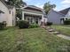 Charming home featuring manicured lawn and welcoming front porch with inviting chairs at 1228 Rising Oak Dr, Charlotte, NC 28206