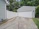 View of detached garage with white fence at 1228 Rising Oak Dr, Charlotte, NC 28206