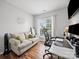 Cozy home office with natural light, comfortable seating, and wood look flooring at 1228 Rising Oak Dr, Charlotte, NC 28206