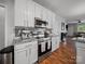 Well-lit kitchen featuring stainless steel appliances, granite countertops, and stylish backsplash at 1228 Rising Oak Dr, Charlotte, NC 28206
