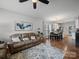 Inviting living area featuring a ceiling fan, hardwood floors, and comfortable seating, perfect for relaxation at 1228 Rising Oak Dr, Charlotte, NC 28206