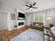 Cozy living room featuring a fireplace, hardwood floors, and comfortable seating, perfect for relaxation at 1228 Rising Oak Dr, Charlotte, NC 28206