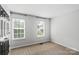 Well-lit bedroom with two windows providing ample light and plush carpeting at 13010 Indian Hills Ln, Charlotte, NC 28278