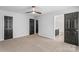 This bedroom features neutral carpet and paint with dark doors and bathroom access at 13010 Indian Hills Ln, Charlotte, NC 28278