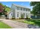 Attractive two-story home with large windows, landscaping, and a well-maintained front lawn at 13010 Indian Hills Ln, Charlotte, NC 28278
