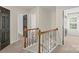 Hallway with staircase, railing and black doors at 13010 Indian Hills Ln, Charlotte, NC 28278