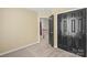 Upstairs hallway with carpet, wood railing, and black doors at 13010 Indian Hills Ln, Charlotte, NC 28278