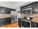 Modern kitchen featuring stainless steel appliances, granite countertops, and dark wood cabinetry at 13010 Indian Hills Ln, Charlotte, NC 28278